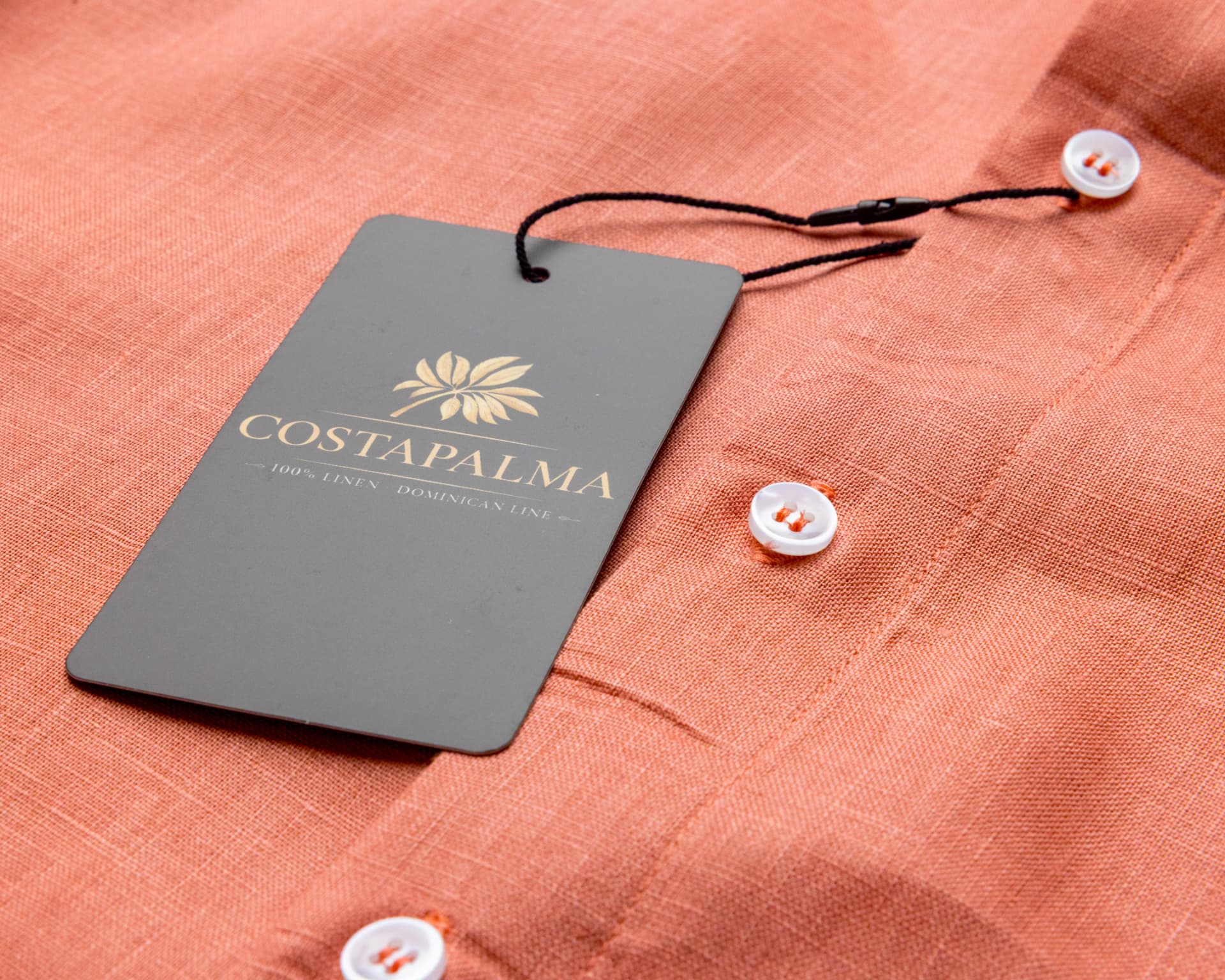 Man in a light linen guayabera at a coastal wedding setting